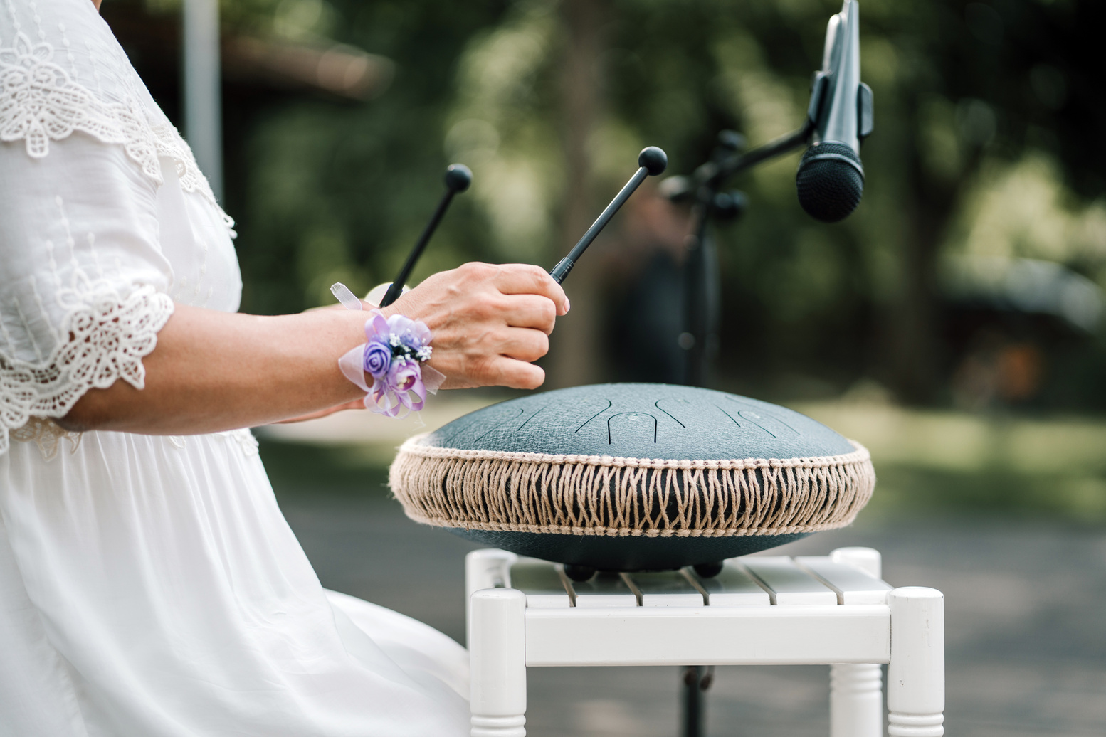 Close up of hands of mid adult woman playing the handpan